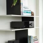 Lyngdorf TDAI-1120 Compact Streaming Amplifier with RoomPerfect lifestyle shot of unit on shelf
