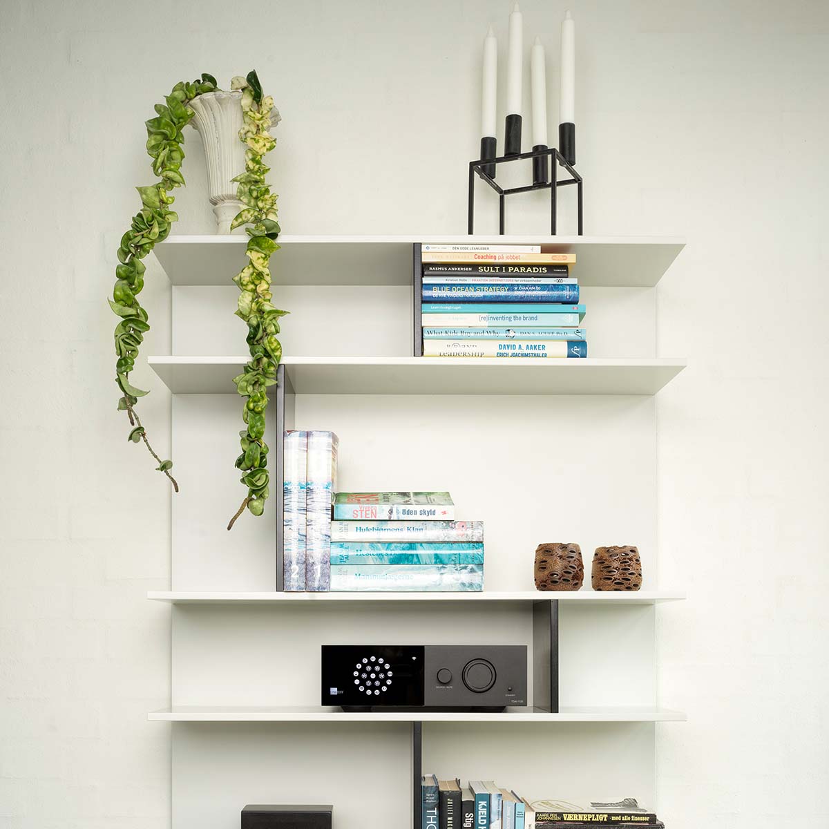 Lyngdorf TDAI-1120 Compact Streaming Amplifier with RoomPerfect lifestyle shot of unit on shelf