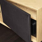 Lyngdorf CS-1 Speaker lifestyle shot of speaker in cabinet with door grille mostly closed