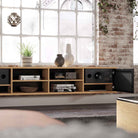 Lyngdorf CS-1 Speaker lifestyle shot of speaker in cabinet with door grille open