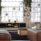 Lyngdorf CS-1 Speaker lifestyle shot of speaker in cabinet with door grille closed