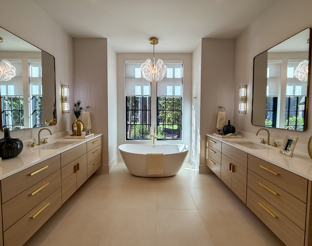Modern bathroom with freestanding bathtub, double vanity, and large mirrors.