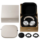 Loewe over-ear wireless headphones in silver and beige, shown with their branded packaging, carrying case, cable, and protective cover on a white background.