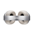 A pair of white over-ear headphones with a metallic silver headband featuring the LOEWE. logo, shown against a plain white background.