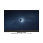 A modern flat-screen television with a Loewe Motorized Table Stand - Stellar 77-83" Alu displaying a dark night sky with a glowing moon on the screen, set against a plain white background.