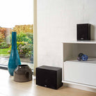 Lyngdorf MH-3 Black Satellite Speaker lifestyle photo with grille on shelf