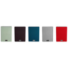 Lyngdorf MH-2 Satellite Speaker five speakers in a row with all grille colors: from left to right green, black, blue, gray and red
