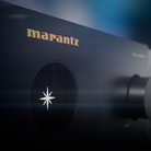 A close-up shot of a Marantz Cinema 60 Series 2 AV Receiver, showing the gold 'marantz' logo and the brand's starburst emblem on a dark matte surface.