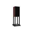 A Mission 700 Bookshelf Speaker on a black rolling display stand, featuring a dark brown wood-grain side panel and a black front grille, set against a plain white background.