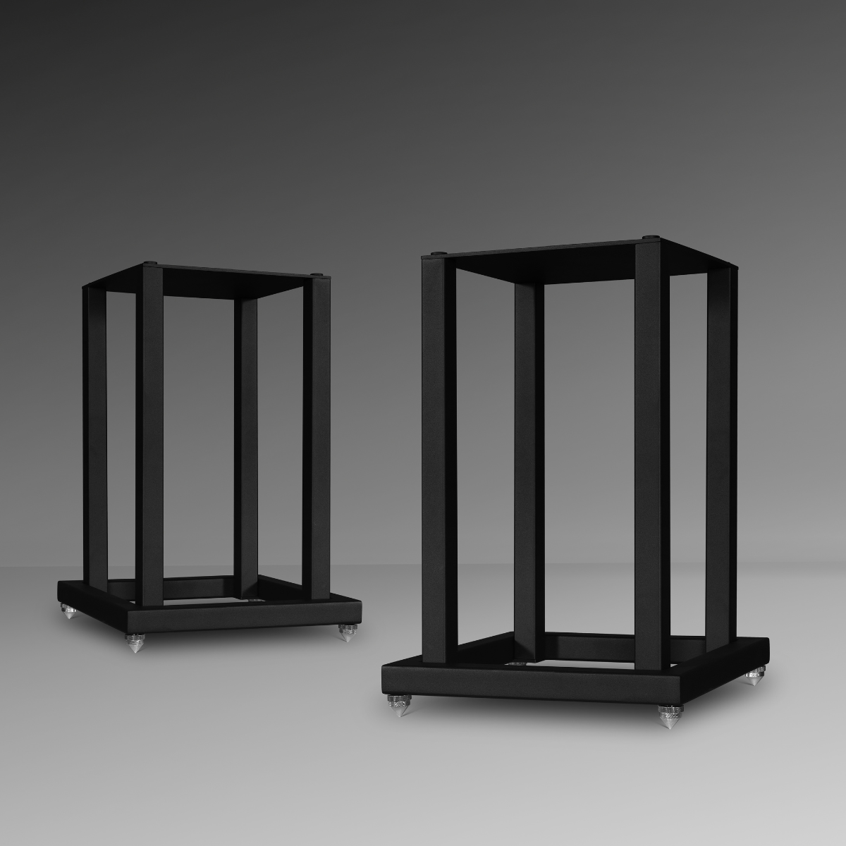 Two black metal Mission 700 Bookshelf Speaker Stands, shown on a dark gray gradient studio background.