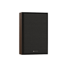 A single wall-mounting speaker with a dark charcoal fabric grille and a dark brown wood-look side panel, shown against a plain white background.