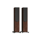 A pair of tall Monitor Audio Silver 300 8G 3-Way Floor Standing Speakers with dark brown wood-grain cabinets and black front baffle panels, shown on a plain white background.
