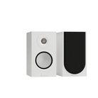 Two white bookshelf speakers shown on a plain white background, one facing forward with a black front baffle and silver driver, and the other showing the side profile.