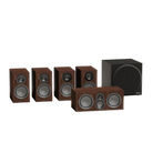 Monitor Audio Silver 50 8G Compact 2-way Bookshelf surround sound system including four wood-grain speakers and a black subwoofer on a white background.