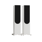 A pair of tall, slim fMonitor Audio Silver Silver 500 8G 3-way Floor Standing Speaker with white bodies and black front panels, standing on small feet against a plain white background.