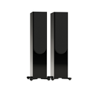A pair of tall, black floor-standing speakers with a glossy finish and small feet, shown against a solid white background.