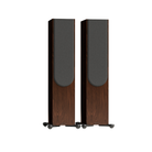 A pair of tall Monitor Audio Silver Silver 500 8G 3-way Floor Standing Speakers with dark brown wood-grain cabinets, a dark gray front baffle, and small black feet with silver caps, shown against a solid white background.