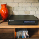NAD C 589 CD Player - lifestyle photo front view of unit on cabinet