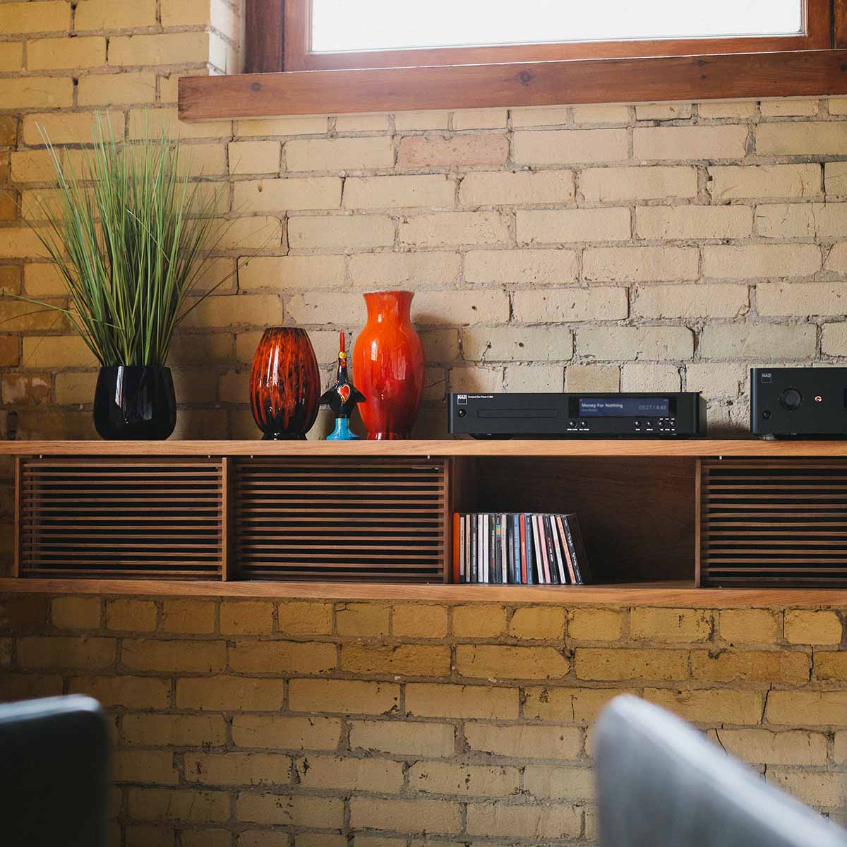 NAD C 589 CD Player - lifestyle photo front view of unit on cabinet