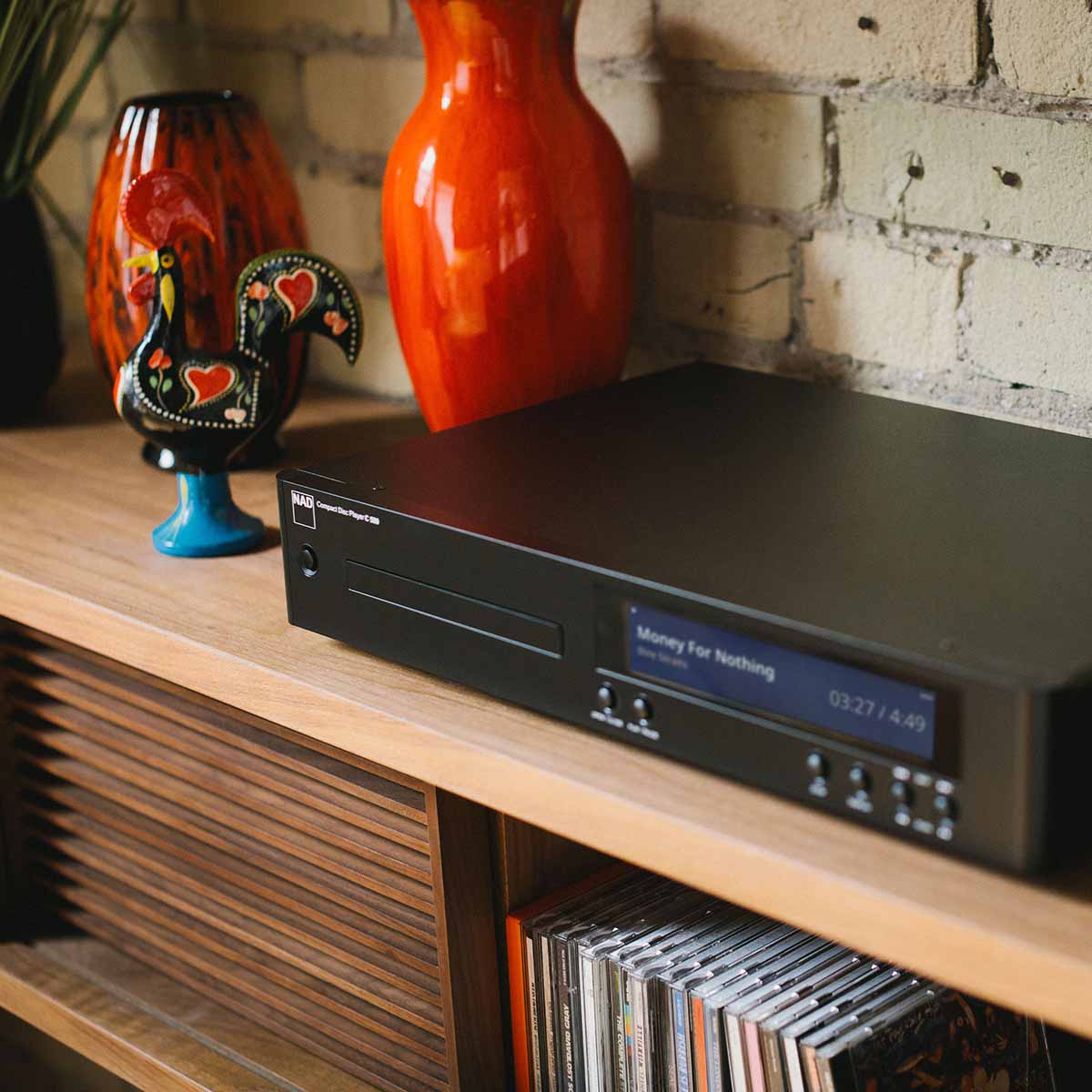 NAD C 589 CD Player - lifestyle photo front view angled left of unit on cabinet