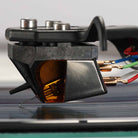 Rega ND9 Moving Magnet Phono Cartridge - side view of cartridge mounted on tone arm with needle on record