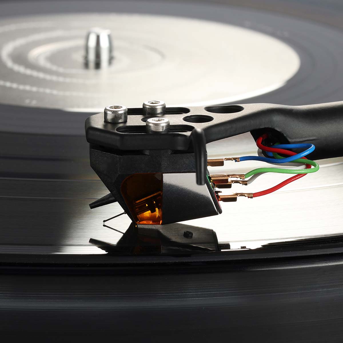 Rega ND9 Moving Magnet Phono Cartridge - side and top view of cartridge mounted on tone arm with needle on record