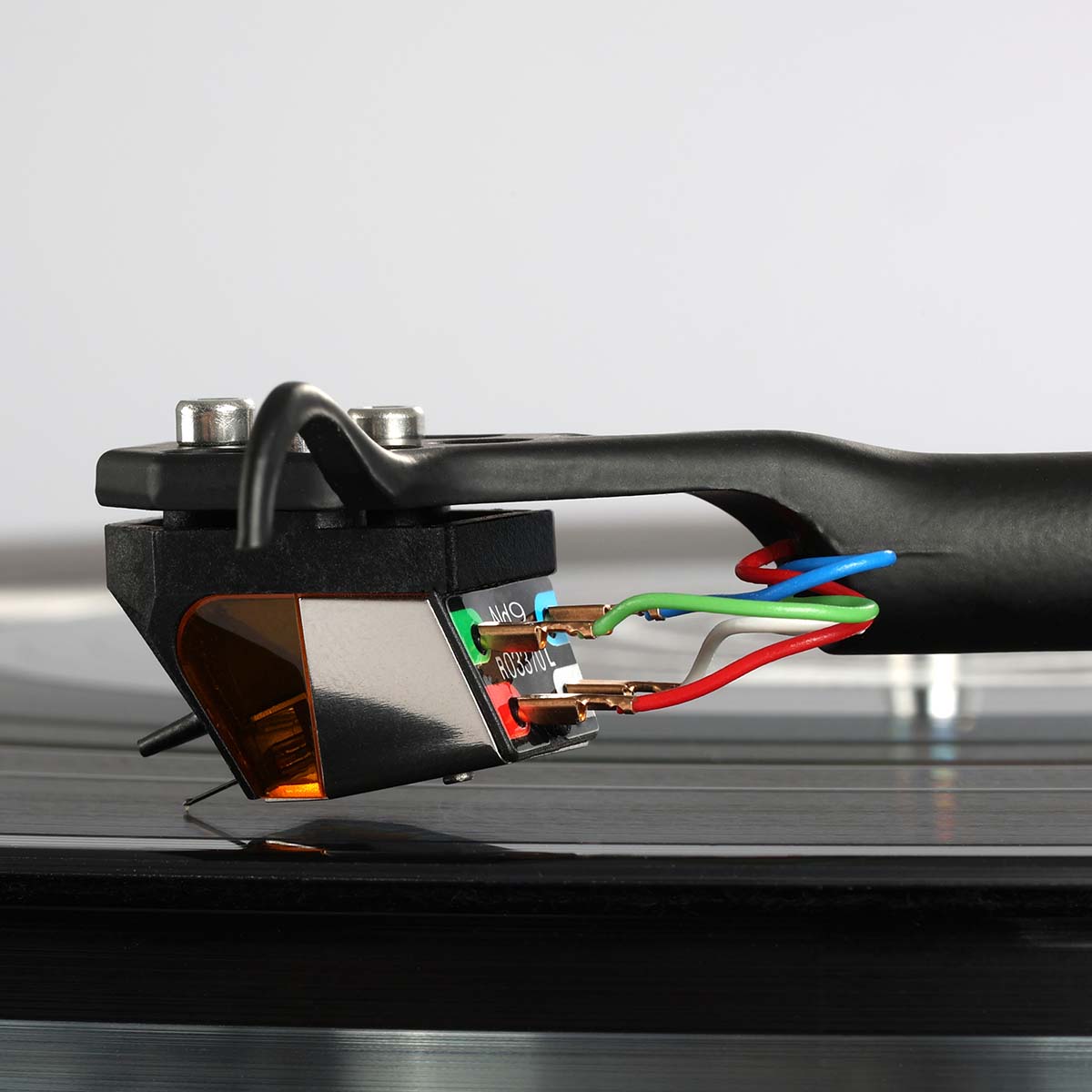 Rega ND9 Moving Magnet Phono Cartridge - side and rear view of cartridge mounted on tone arm with needle on record showing wire connections