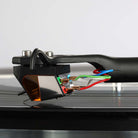 Rega ND9 Moving Magnet Phono Cartridge - side and rear view of cartridge mounted on tone arm with needle on record showing wire connections
