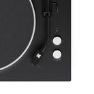 Close-up of a black turntable with white control knobs on a white background