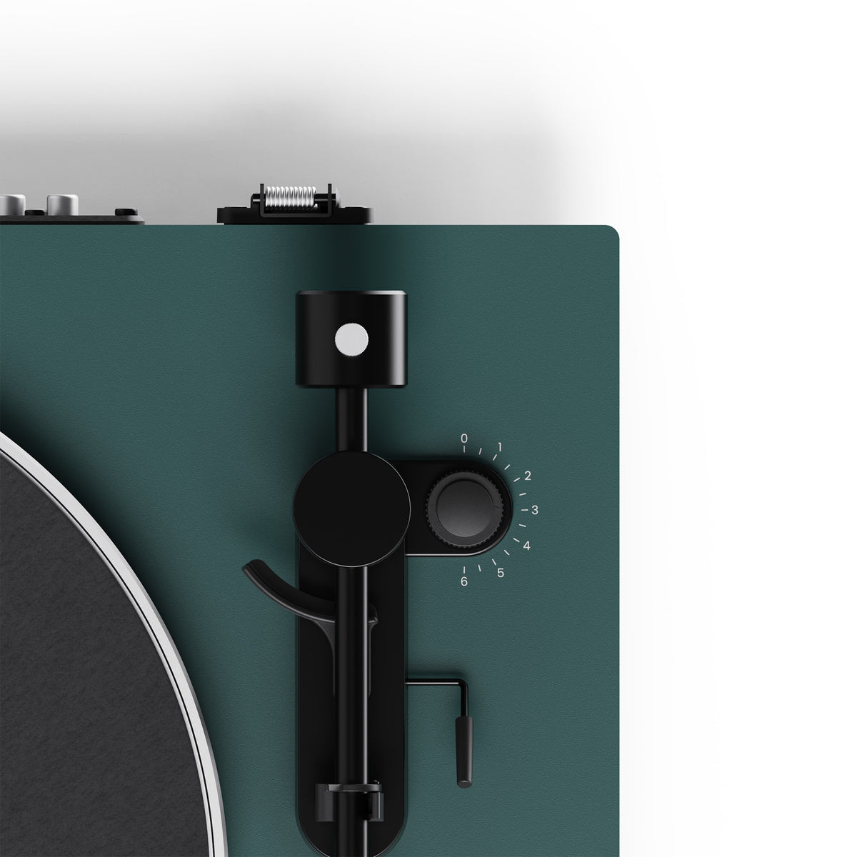 Close-up of a turntable with a green plinth and black control panel.