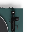 Close-up of a turntable with a green plinth and black control panel.