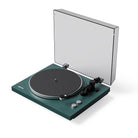 Green turntable with a clear dust cover on a white background