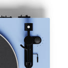 Close-up of a turntable with a blue base and black control panel.