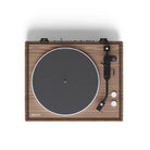 Wooden record player with black turntable on a white background