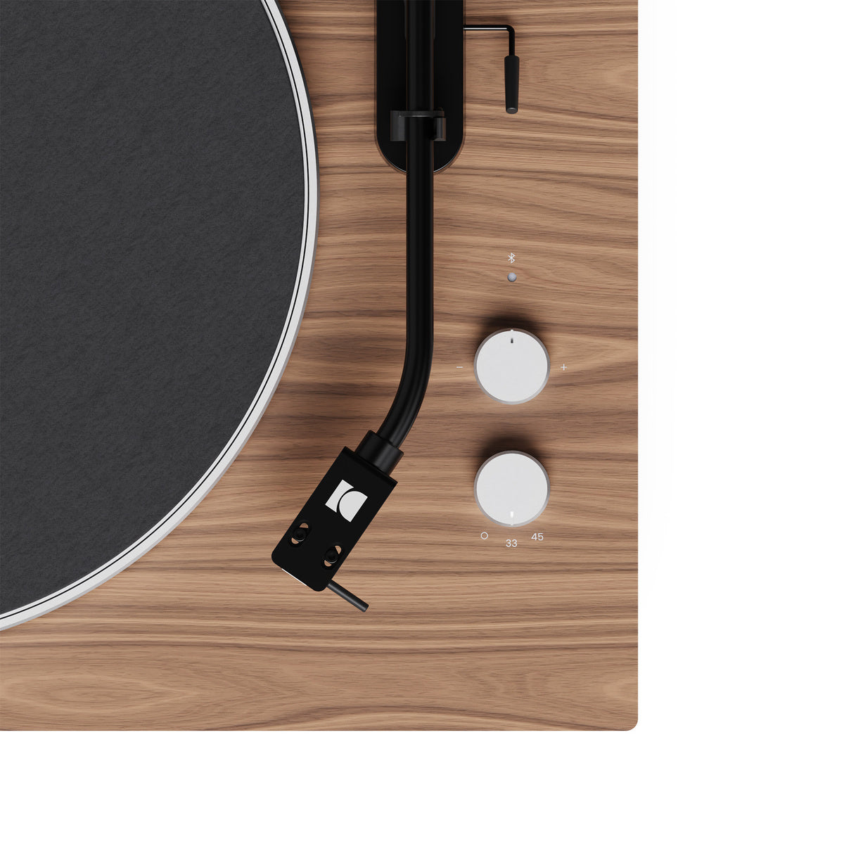 Close-up of a turntable with a wooden finish and black platter.