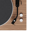Close-up of a turntable with a wooden finish and black platter.