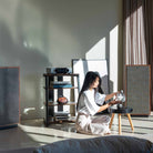 Onkyo Muse Y-50 Network Integrated Amplifier - Silver - lifestyle view of unit on shelf to left with seated woman to right
