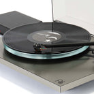 Rega Planar 6 RS Special Edition Turntable - high-angle close-up three-quarter view with open dustcover and record on platter with tone arm engaged