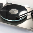 Rega Planar 6 RS Special Edition Turntable - high-angle close-up three-quarter view with open dustcover and record on platter with tone arm engaged