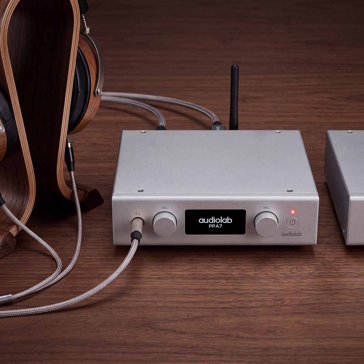 Audiolab PPA7 Phono Preamplifier - Silver - lifestyle photo of unit on desk to right of headphones on stand