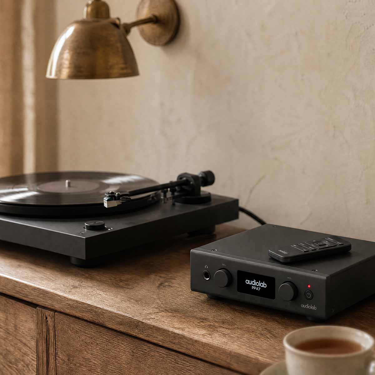 Audiolab PPA7 Phono Preamplifier - Black - lifestyle photo of unit on cabinet to right of turntable
