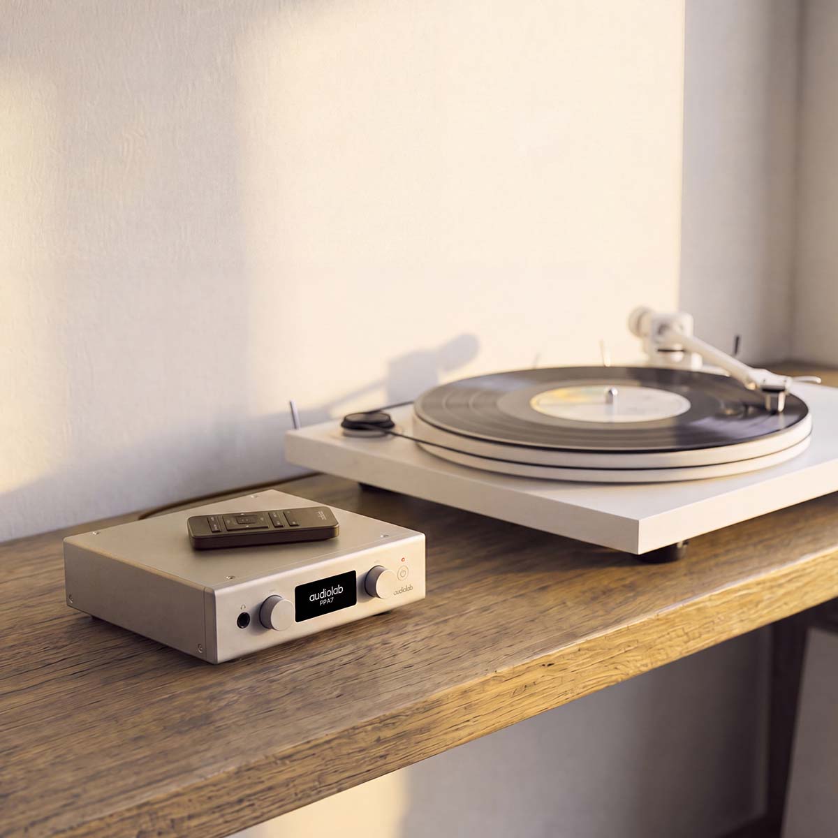 Audiolab PPA7 Phono Preamplifier - Silver - lifestyle photo of unit on cabinet to left of turntable