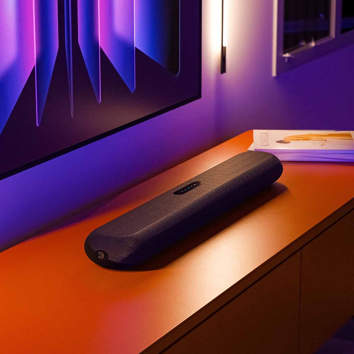 Bluesound Pulse Cinema Mini Multi-Room Streaming Soundbar Black lifestyle photo of unit on cabinet below TV