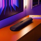 Bluesound Pulse Cinema Mini Multi-Room Streaming Soundbar Black lifestyle photo of unit on cabinet below TV