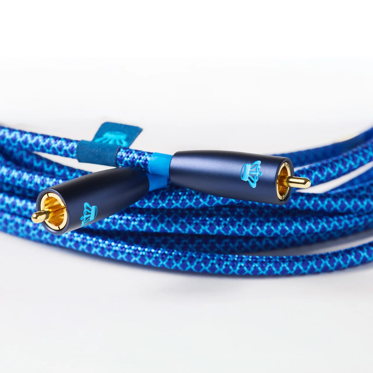 Blue braided audio cable with gold-plated RCA connectors and a blue logo on the connectors, photographed on a clean white background.