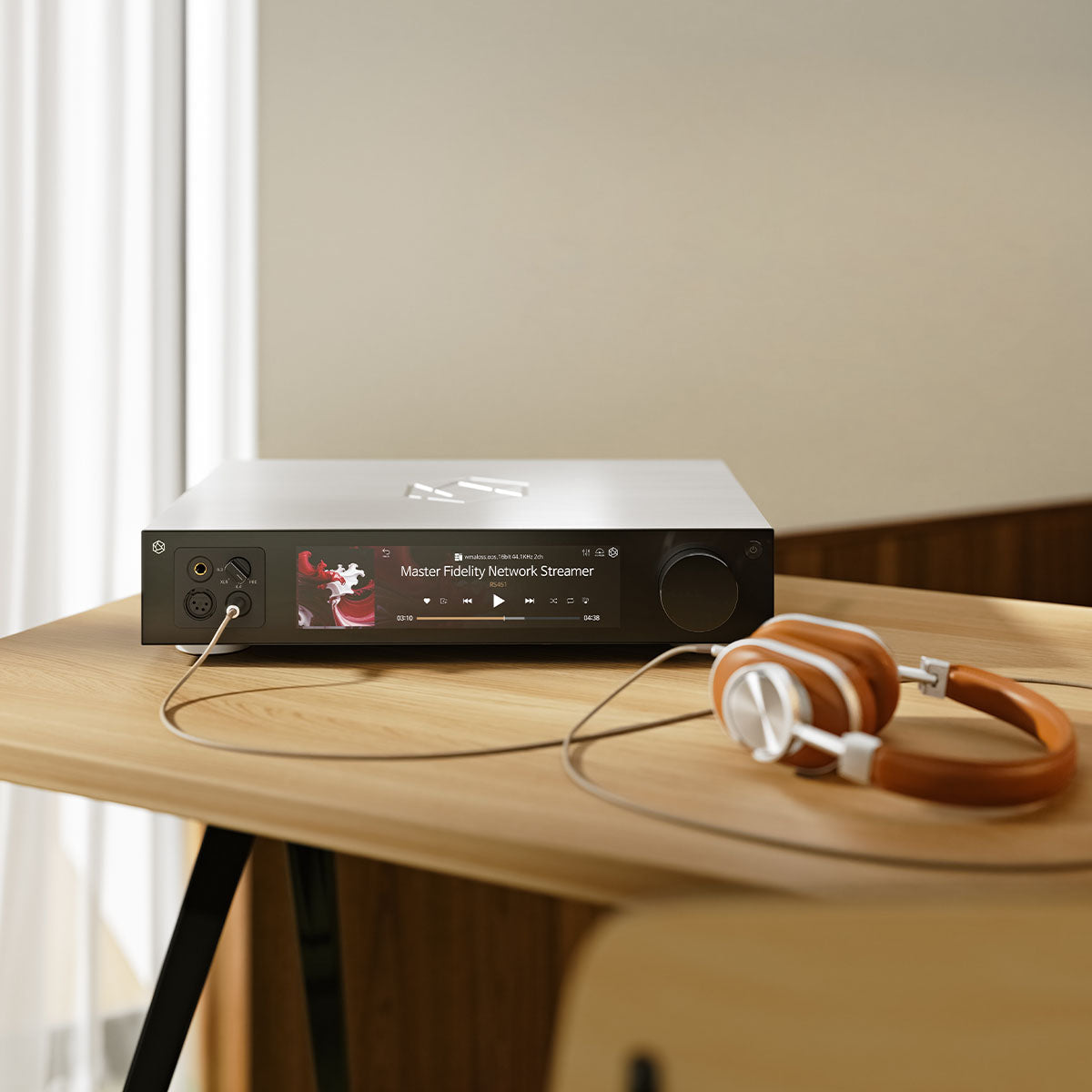 HiFi Rose RS451 Network Streamer and DAC - silver - front view lifestyle photo of unit on table with headphones connected