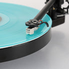 Rega Replay Turntable - detail of tonearm engaged over blue record