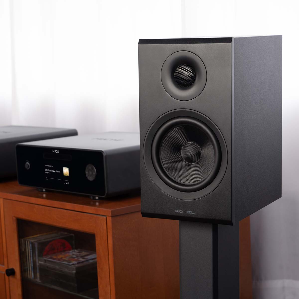 Rotel Amora 5 Passive Bookshelf Loudspeakers - Black - Lifestyle photo front and side view angled left without grille