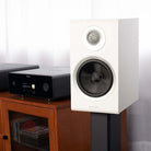 Rotel Amora 5 Passive Bookshelf Loudspeakers - White - Lifestyle photo front and side view angled left without grille