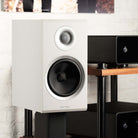 Rotel Amora 5 Passive Bookshelf Loudspeakers - White - Lifestyle photo front and side view angled right without grille
